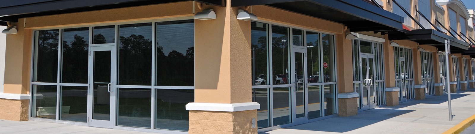 Wide showroom storefront with massive high-transparency display windows